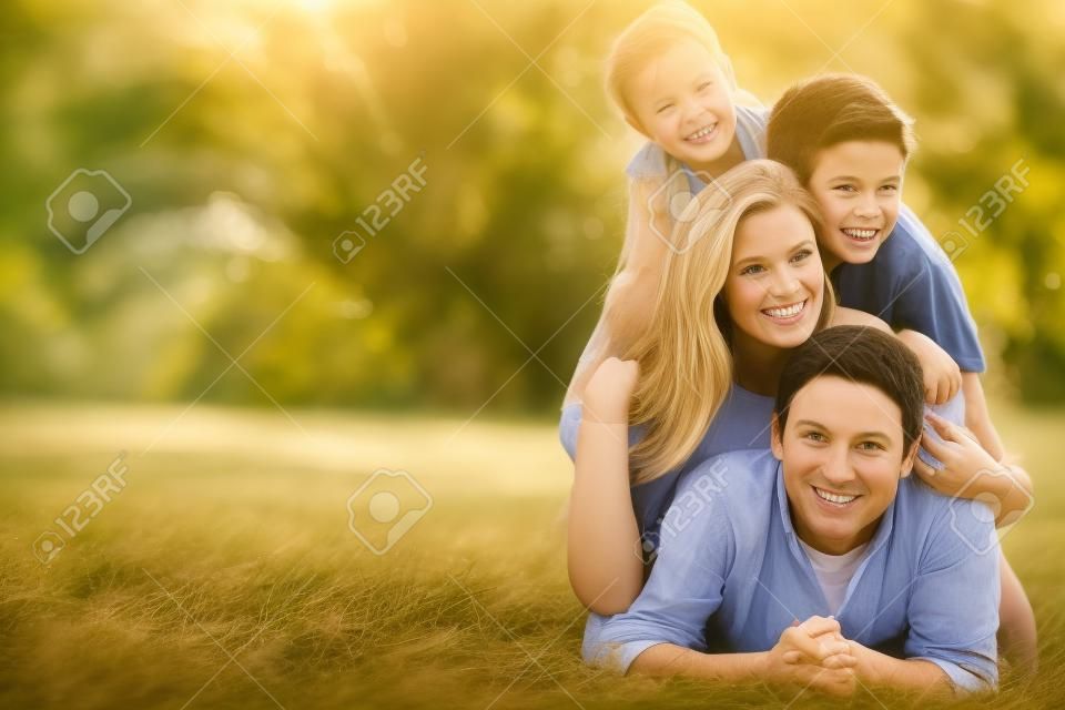 Portrait Of Family Lying On Grass In Countryside