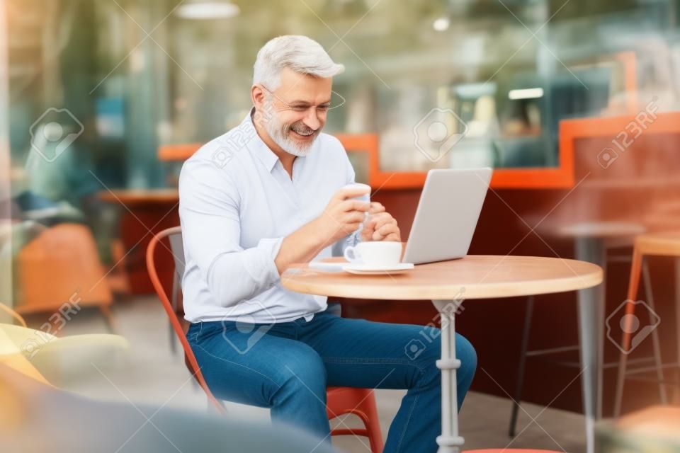 Middle aged man sitting in a cafe