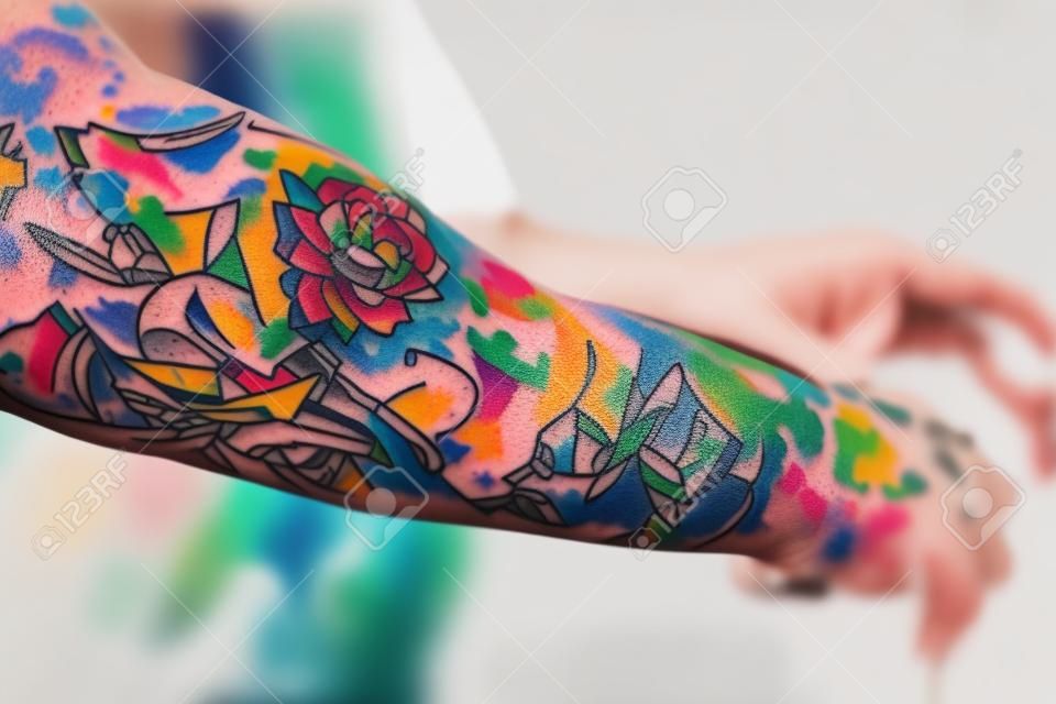 Person arm that is covered in colorful tattoos. Generative AI. high quality illustration