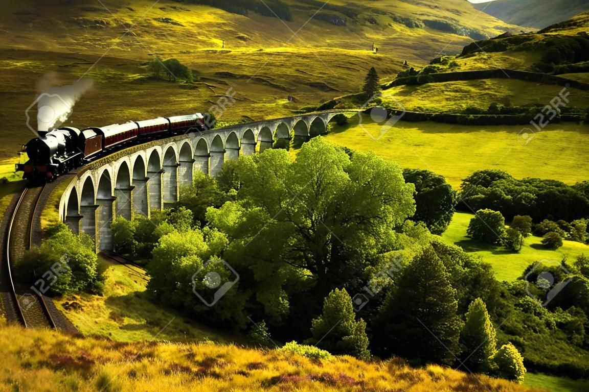 Jacobite steam train on old viaduct in Glenfinnan, Scotland