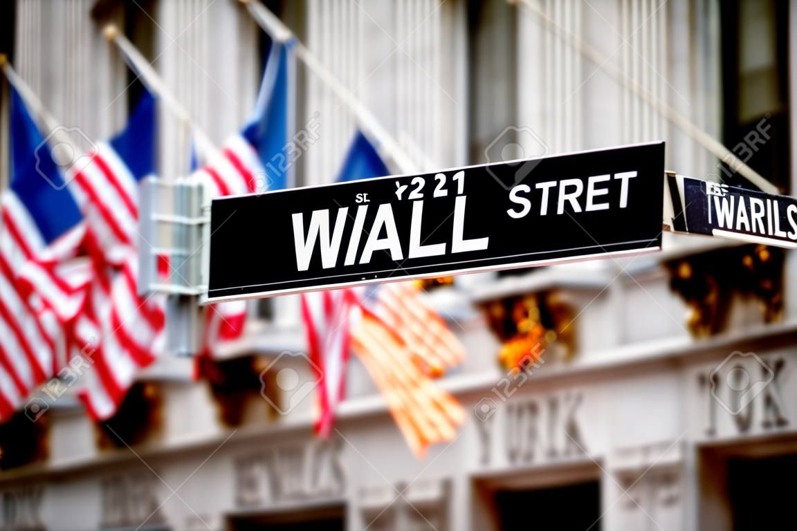 Wall street sign in New York with New York Stock Exchange background 