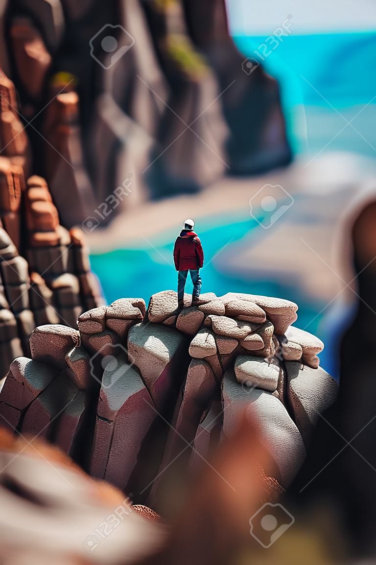 Man on top of the mountain looking at the sea. Travel and adventure concept.