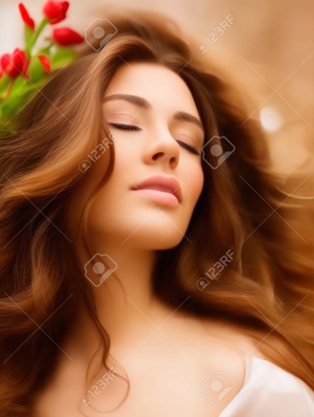 Portrait of a beautiful young brunette woman with closed eyes.