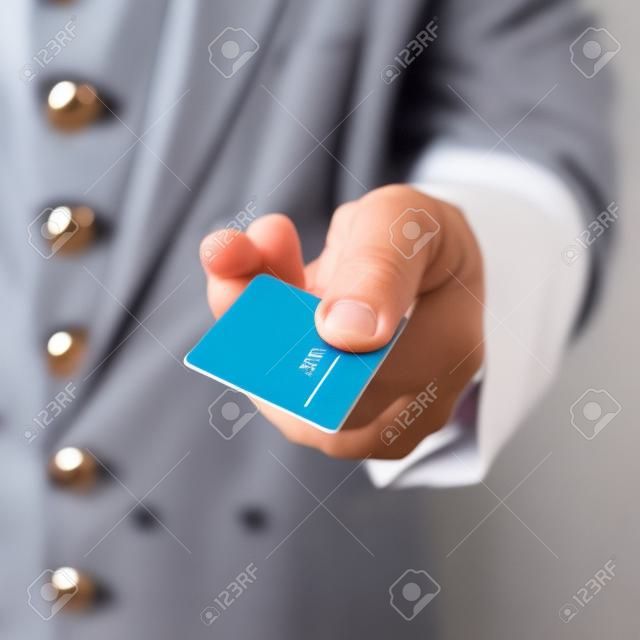 Mano del portero que da la tarjeta llave de la habitación del hotel