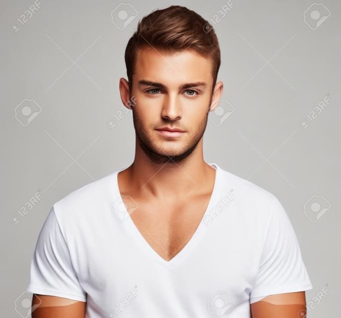 Handsome guy in white t-shirt isolated on a white