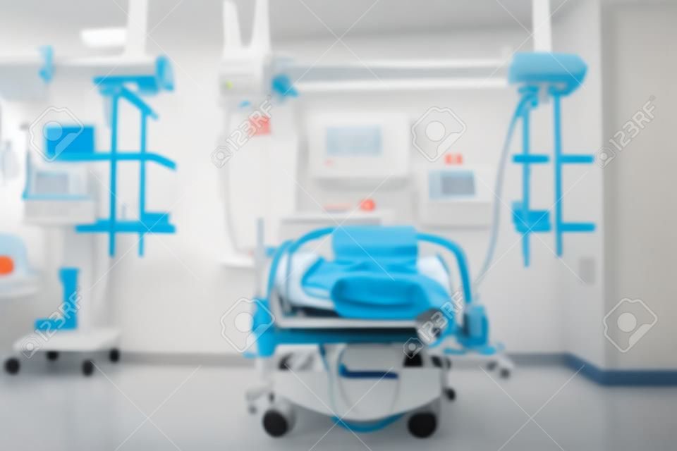 Patient bed in the tidy emergency room, defocused background.