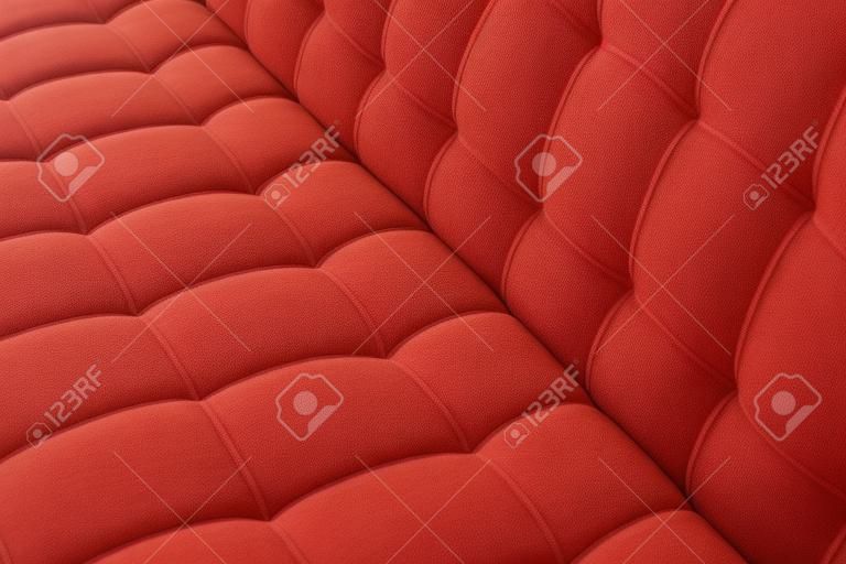 Texture details of red cover soft cotton cloth fine sewing sofa. Fabric pattern of furniture background.