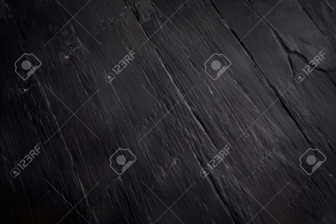 Dark grey black slate background or natural stone texture. Black stone wall and floor