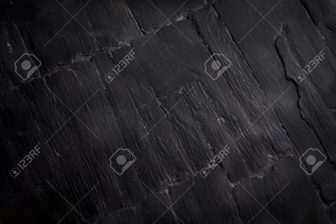 Dark grey black slate background or natural stone texture. Black stone wall and floor