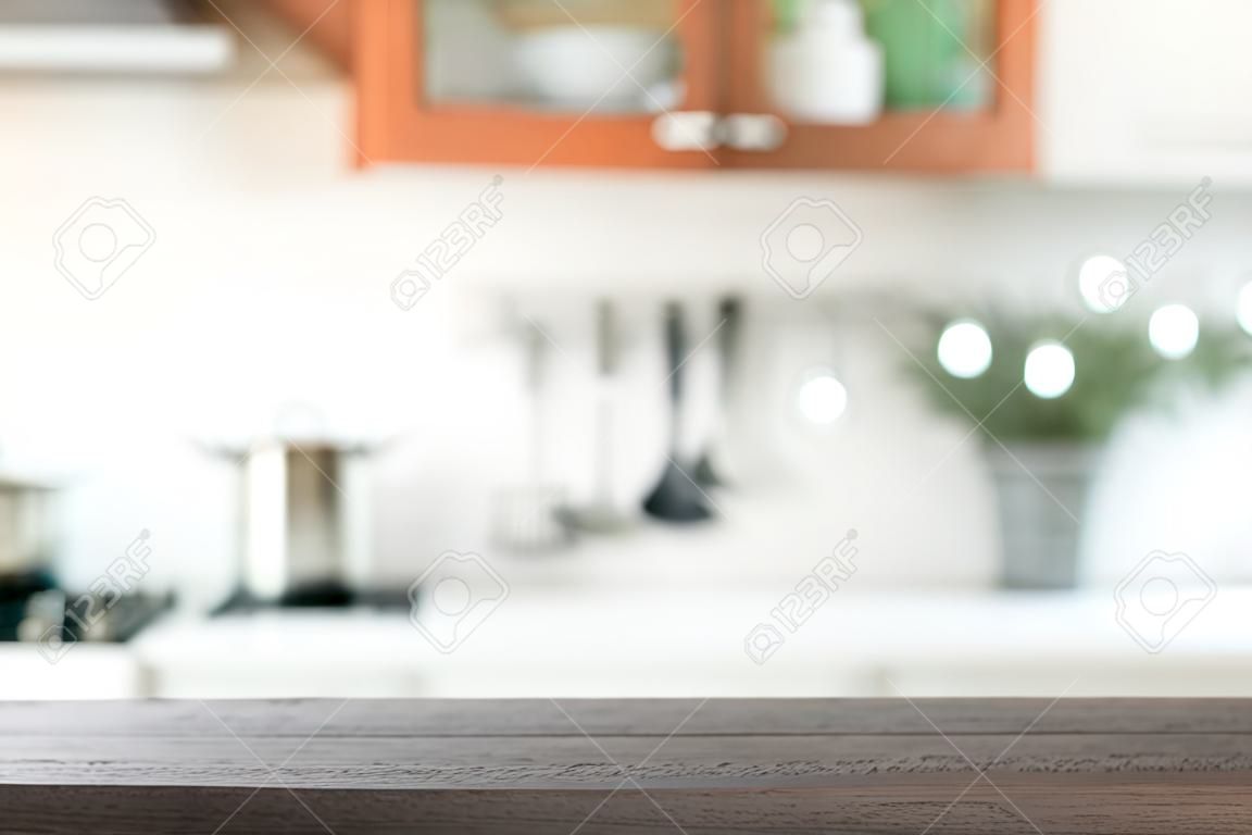 Blurred background. Modern kitchen with tabletop and space for you.