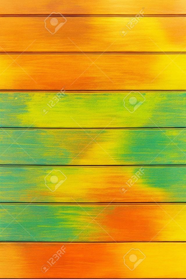 Abstract multicolored colorful vertical striped background in beautiful pastel autumn colors with the surface texture of wooden boards painted in yellow orange green brown colors