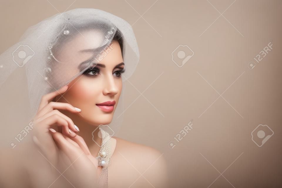 beautiful girl with pearl necklace and veil hat