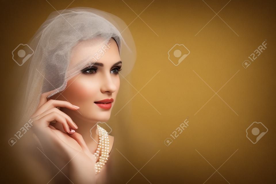 beautiful girl with pearl necklace and veil hat