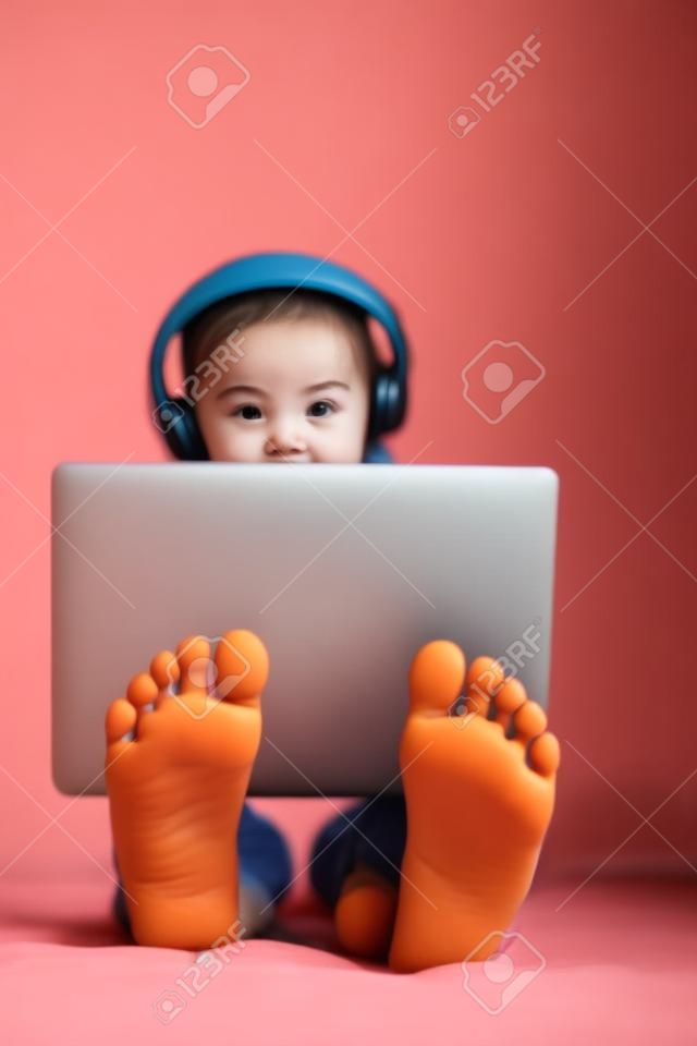 Feet of little girl using laptop