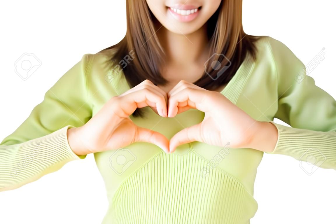 A woman's hands forming a heart symbol on chest