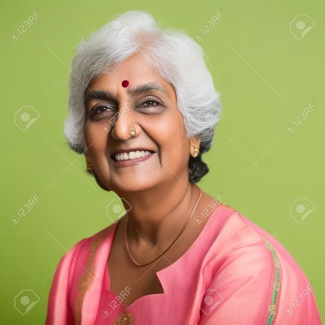 Portrait of a 50s Indian mature woman smiling, isolated on white background.