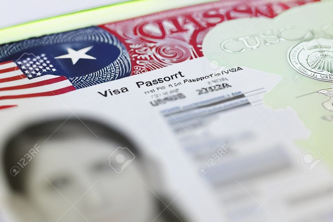 The American Visa in a passport page (USA) background - selective focus