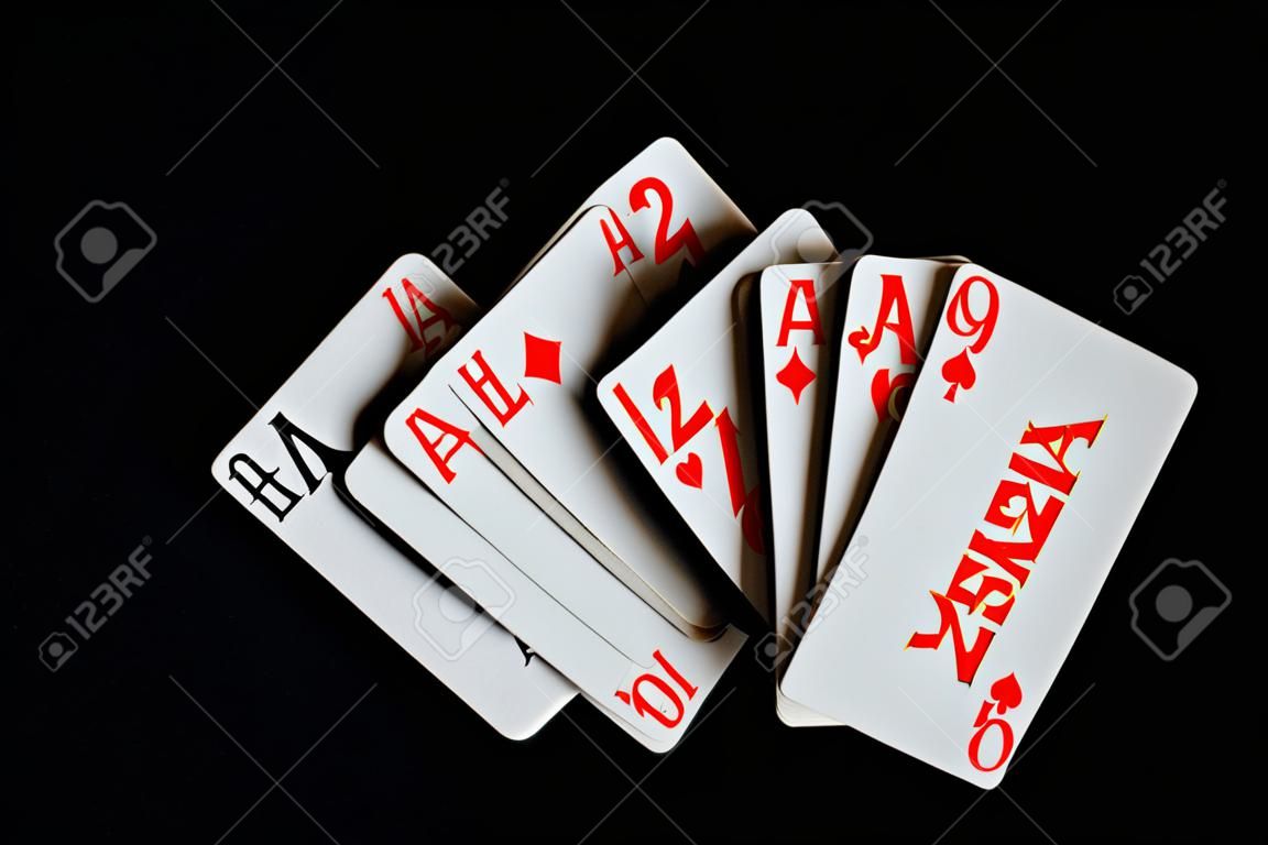 Several playing cards on a dark background close up