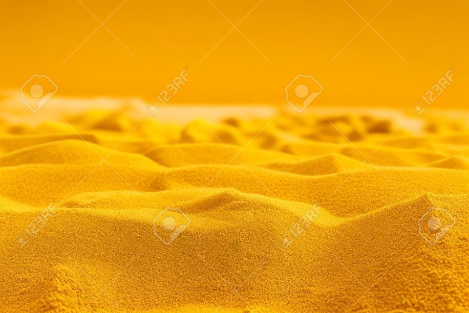 클로즈업에서 촬영하는 노란 모래의 아름다운 질감
