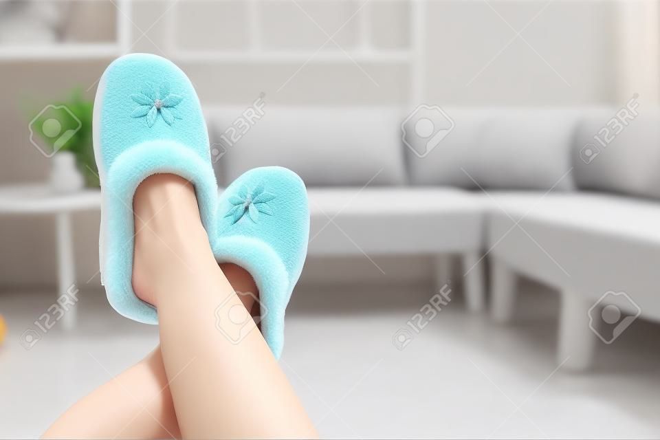 Slippers on women's legs. Soft comfortable home slipper