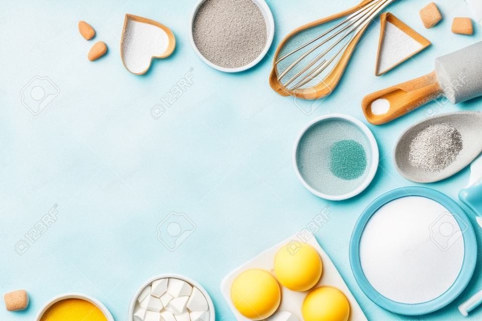Ingredients and utensils for baking on a pastel background, top view.