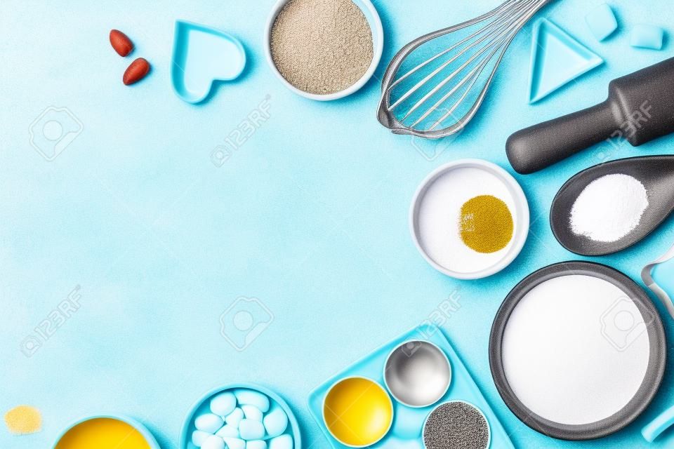 Ingredients and utensils for baking on a pastel background, top view.