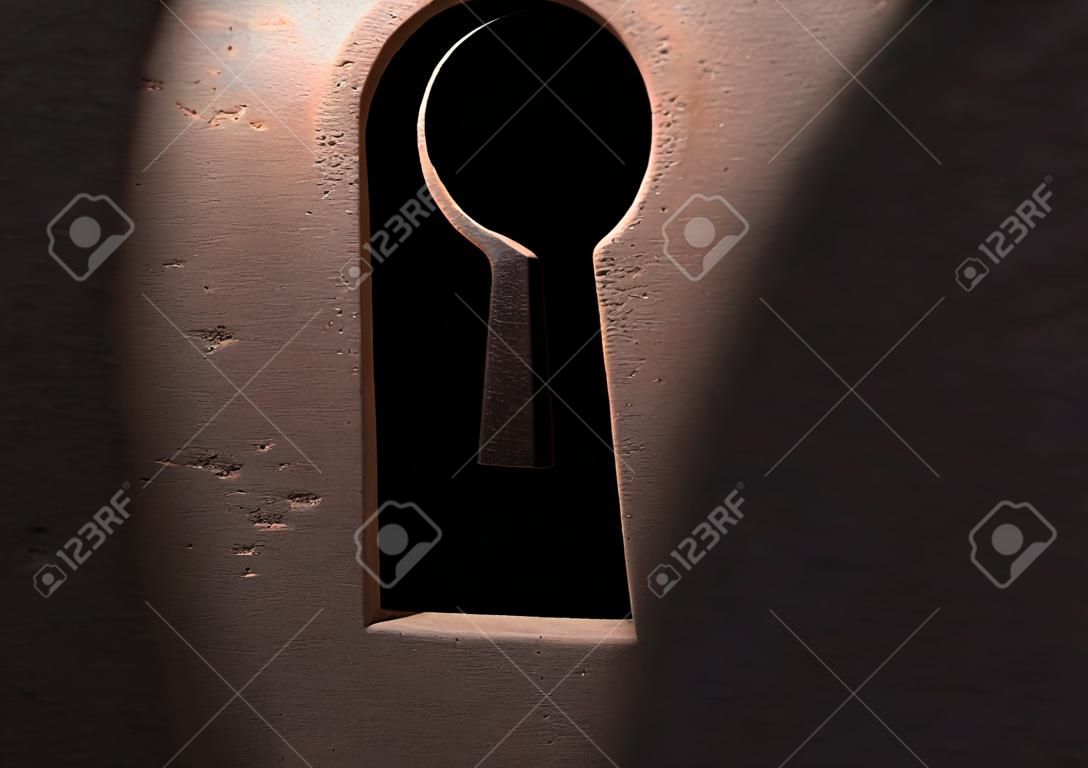 Keyhole in grunge door with light 3d illustration