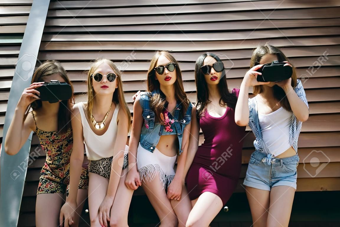Five young beautiful girls on the street looking at the camera