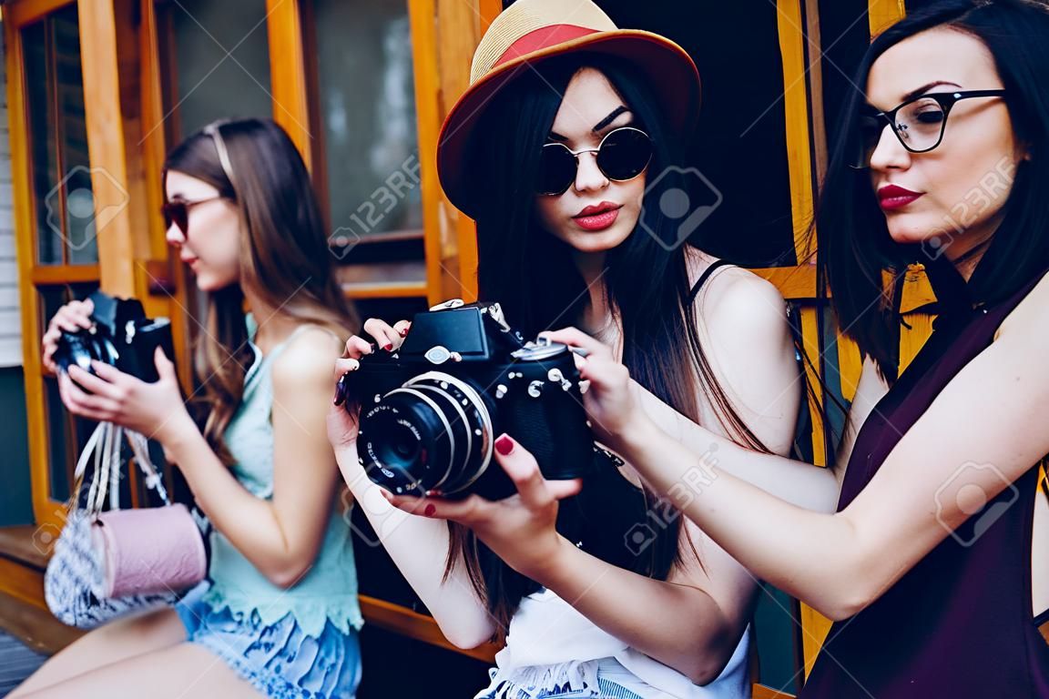 Two beautiful young girls are holding vintage camera