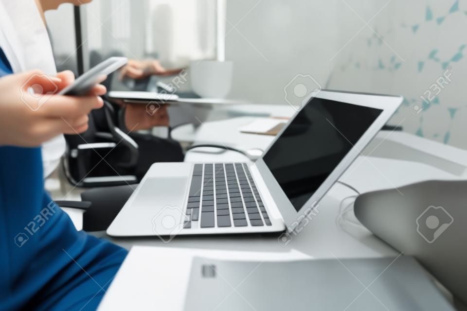 Young woman sitting at office table with laptop.