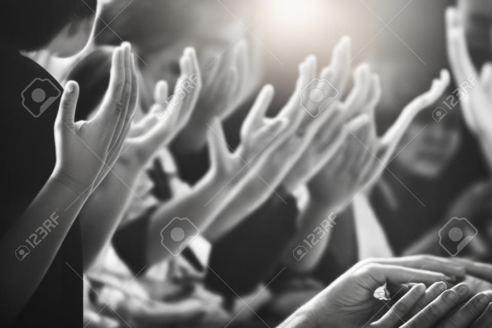 Black and white of group people praying worship believe. soft focus, praying and praise together at church. devotional or prayer meeting concept.
