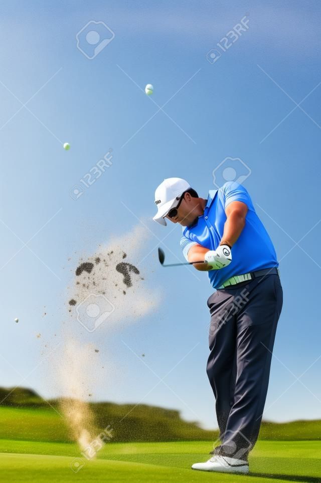 Golfer hitting the ball on the fairway