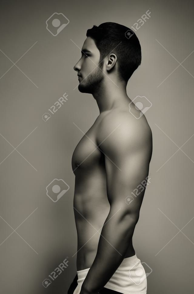 Side or profile view of shirtless young man standing with proper posture or position