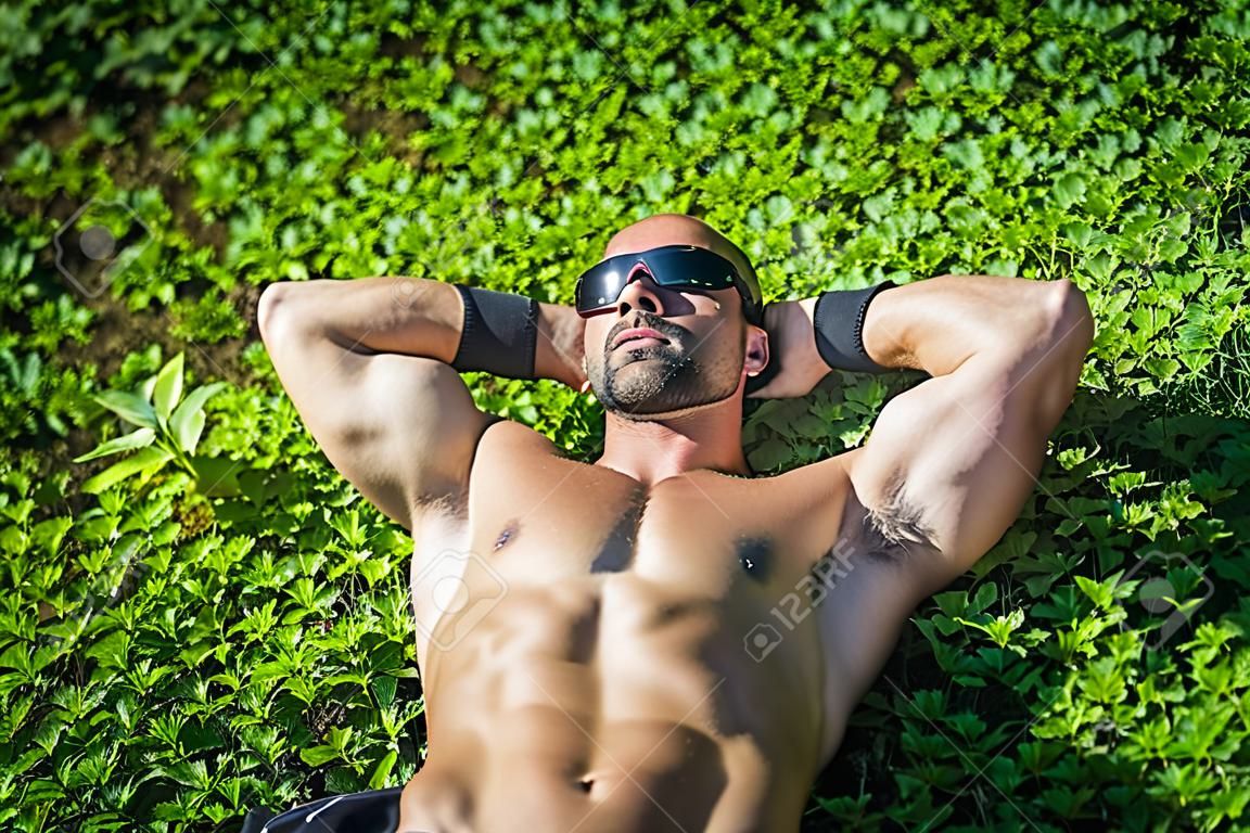 Handsome Muscular Shirtless Hunk Man Outdoor in City Park. Showing Healthy Muscle Body While Looking away