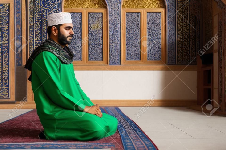 Religious muslim man sitting inside the mosque for praying