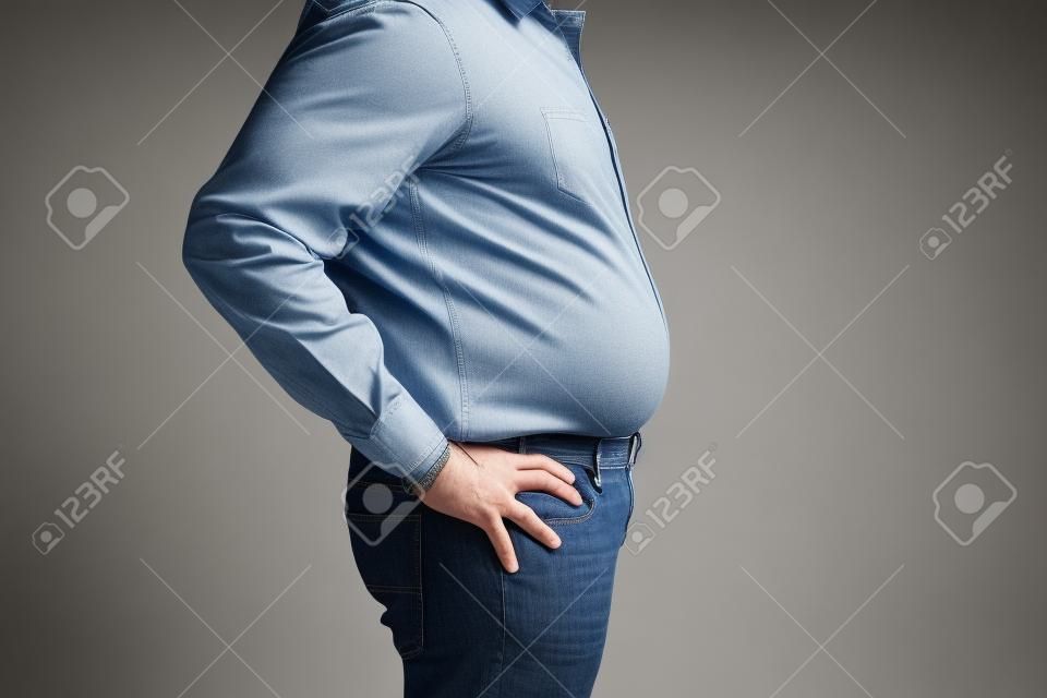 man with a big belly wearing  a shirt and jeans, side view