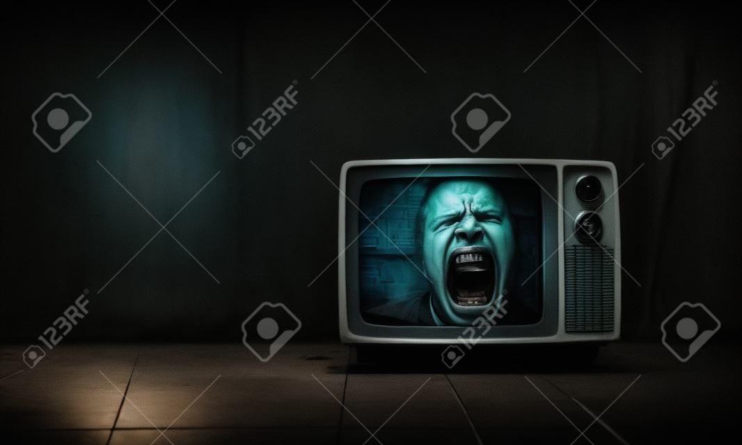 man screams inside an old TV set on the floor. horror movie concept