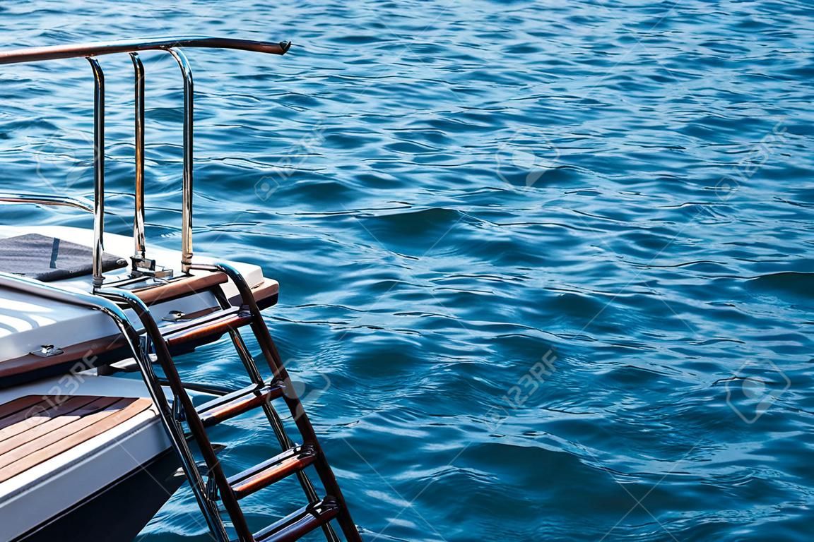 Yacht ladder on a background of small waves