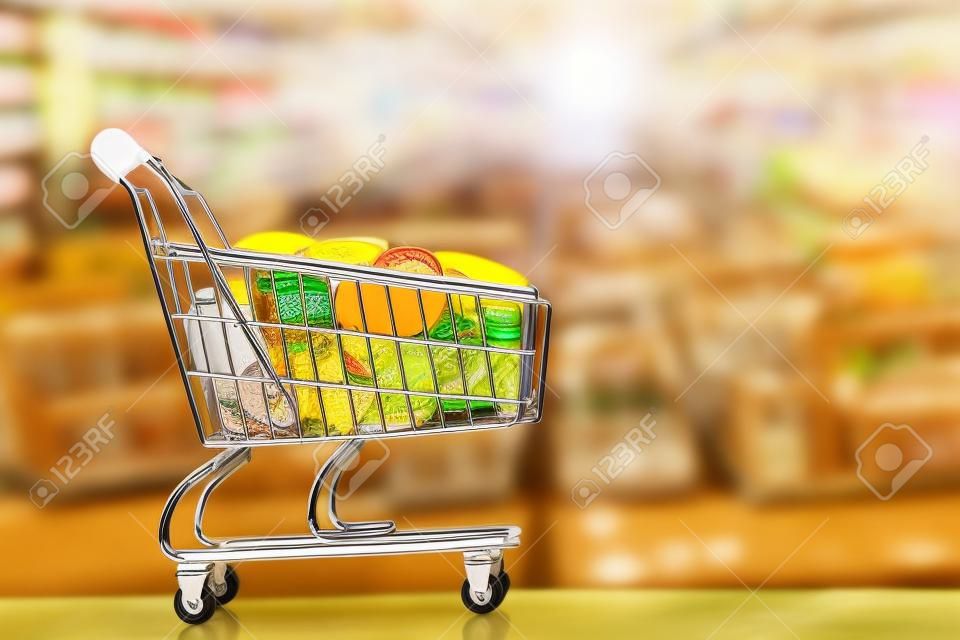 Supermarket trolley with coins, Coin in shopping cart,  concept pay spend saving money, supermarket store, Finance and money