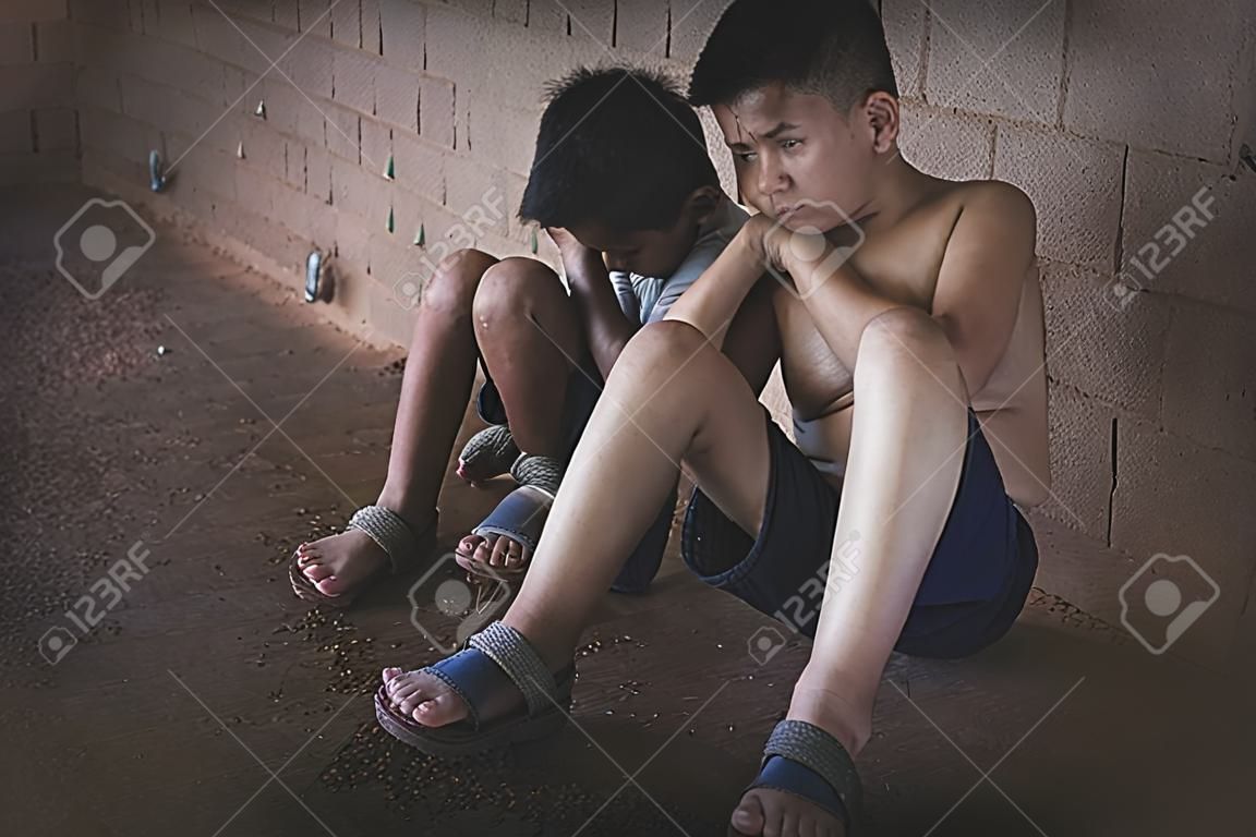 Two boys tied with rope. Abuse. Physical and mental abuse. Waiting for help. Violence against children.