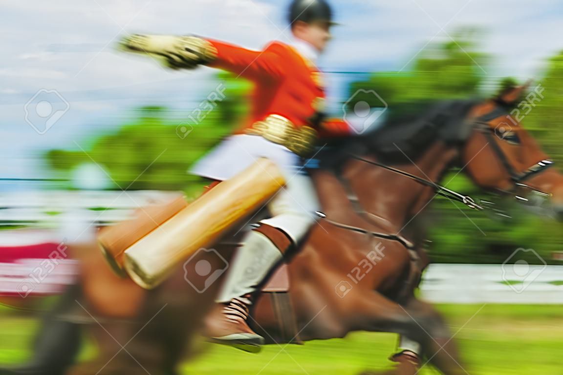 Blurred background- riding a horse. Demonstration performance sports show