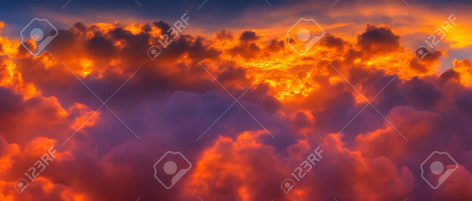 Panoramic sunset. High resolution evening sky background. The setting sun breaking through white clouds