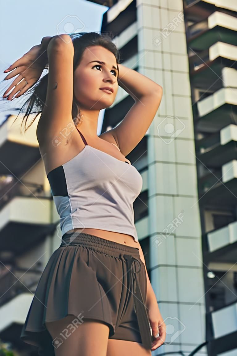 Young beautiful woman with long hair posing in an urban context