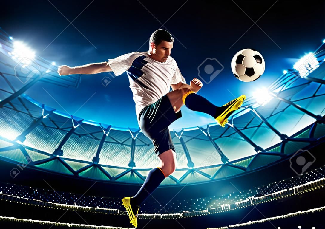 Soccer player in action on night stadium background