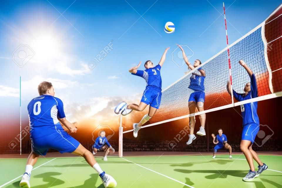 Professional volleyball players in action on the open air court