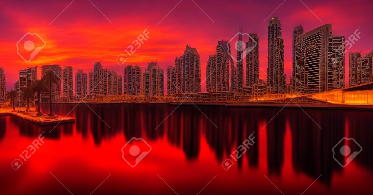 Dubai skyline with reflection at dramatic sunset,  UAE