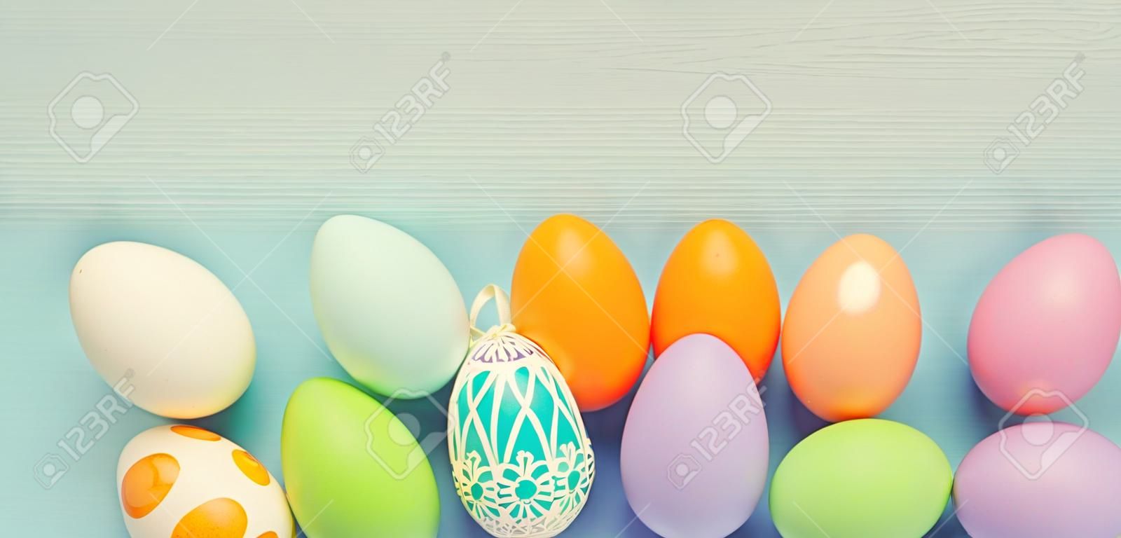 Top view of easter colorful eggs over blue background