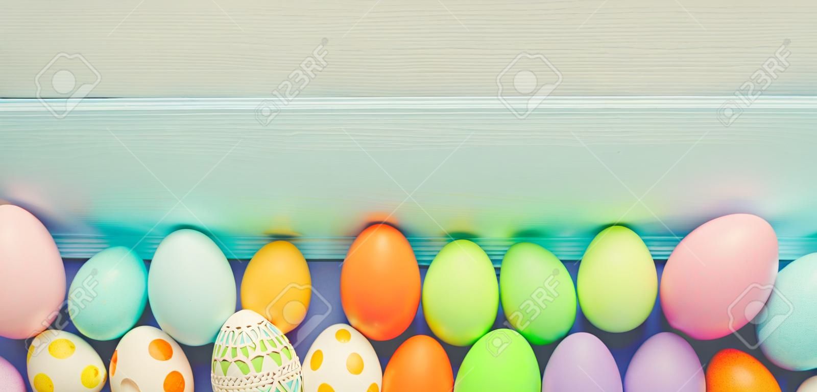 Top view of easter colorful eggs over blue background