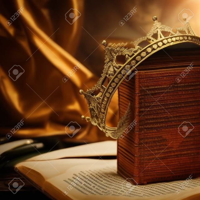 low key image of beautiful queen/king crown on old book. fantasy medieval period