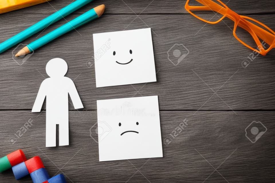Top view image of table with note of happy and sad face. concept of happiness emotion and satisfaction